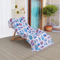 Krissy Mast beach towel draped over a wooden lounge chair on a patio.