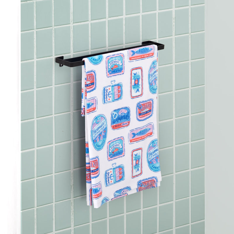 Close up of a Krissy Mast Sardine draped neatly over a metal towel holder in a bathroom.
