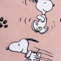 Close up of a pink Peanuts beach towel.
