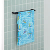 A blue peanuts beach towel draped neatly over a metal rod in a bathroom.
