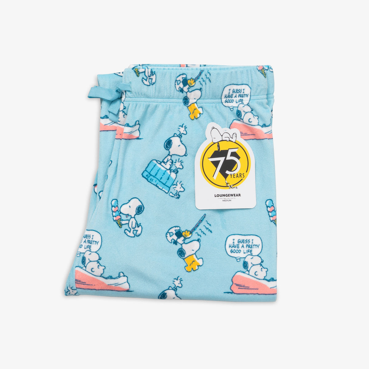 Peanuts 75th Anniversary printed lounge pants folded neatly on a white surface.