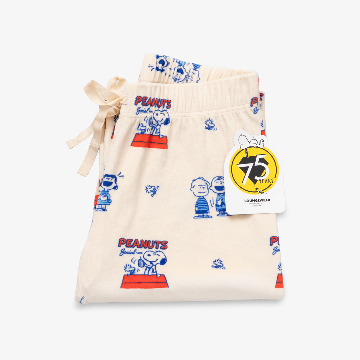 Peanuts 75th Anniversary printed lounge pants folded neatly on a white surface.