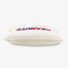 Peanuts Social Club Pillow sitting on a white surface.