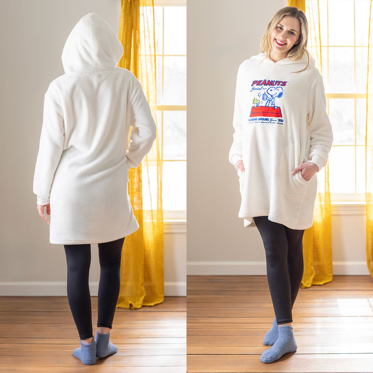 A woman posing in a peanuts lounge hoodie.