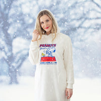 Woman wearing a white hoodie with a 'Peanuts' design in a snowy landscape