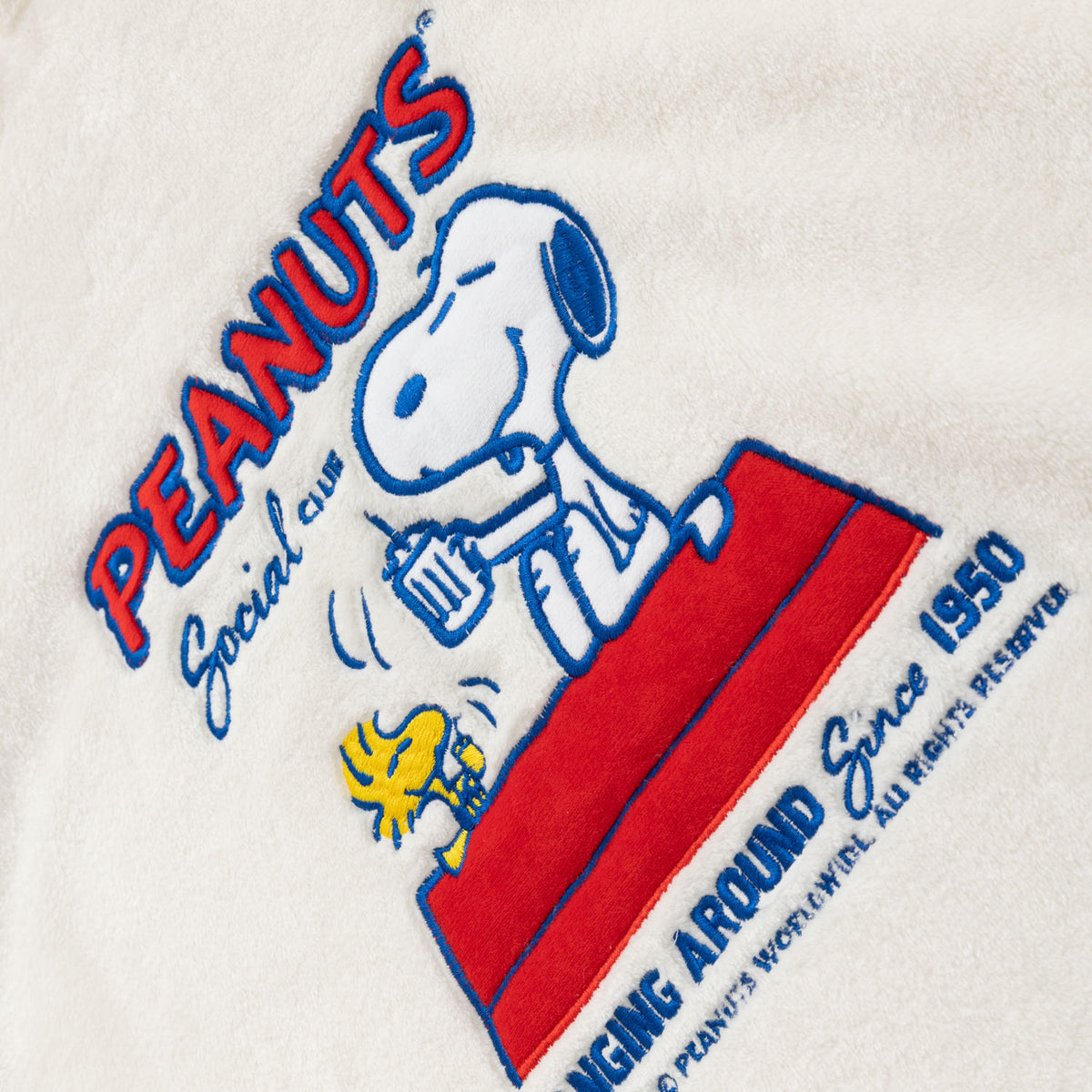 Close up of a Peanuts social club embroidered lounge hoodie.