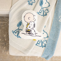 Charlie Brown & Snoopy embroidered pillow laying on our Peanuts MellowSoft Throw.