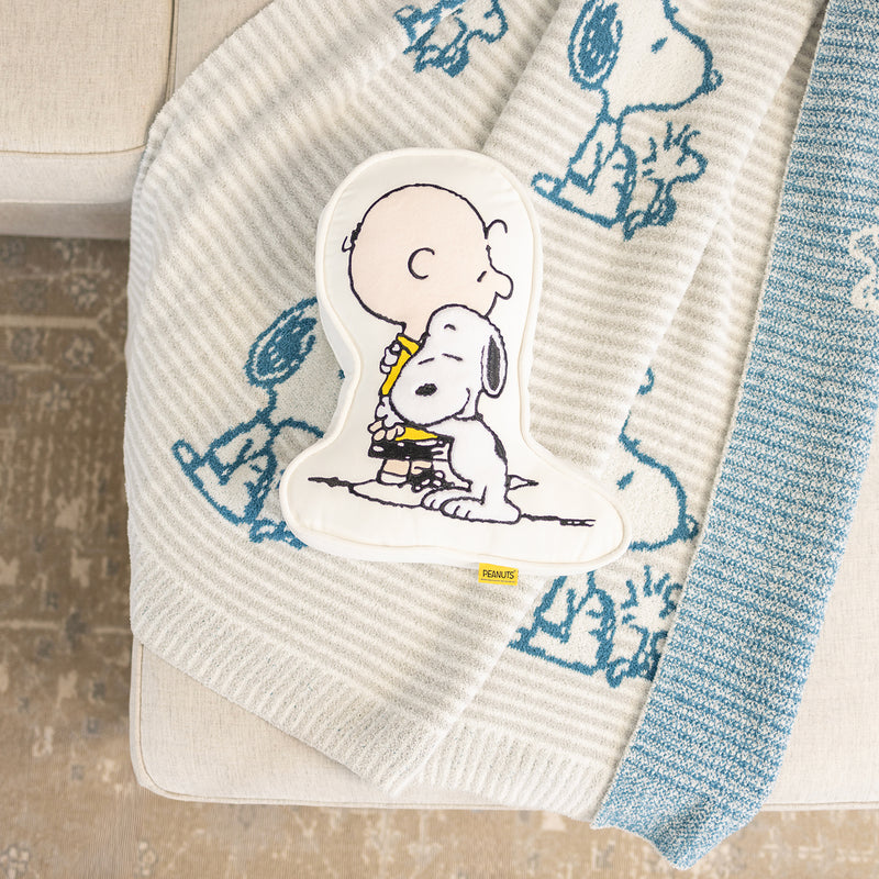 Charlie Brown & Snoopy embroidered pillow laying on our Peanuts MellowSoft Throw.