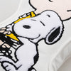 Close up of a Charlie Brown & Snoopy embroidered pillow.