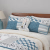 Peanuts patchwork quilt set dressed on a bed with a peanuts pillow.