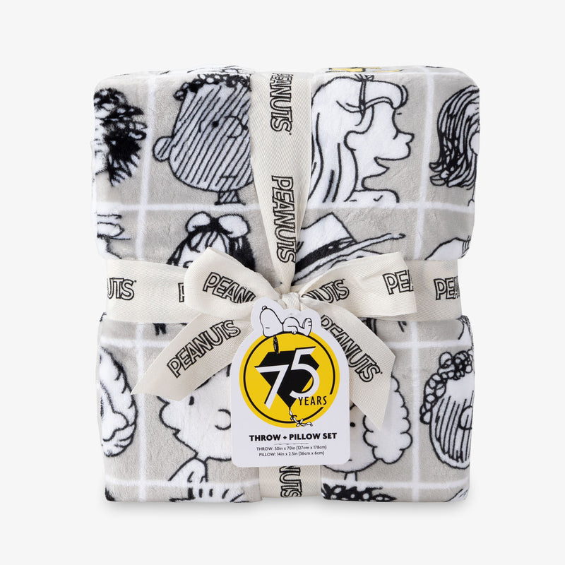 Peanuts 75th Anniversary Throw & Pillow Set sitting on a white surface.