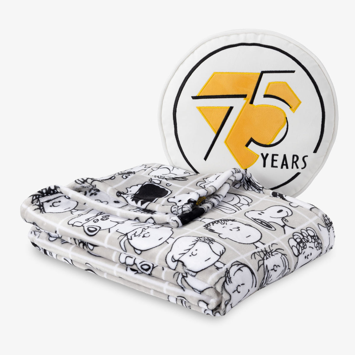 Peanuts 75th Anniversary Throw & Pillow Set draped sitting on a white surface.
