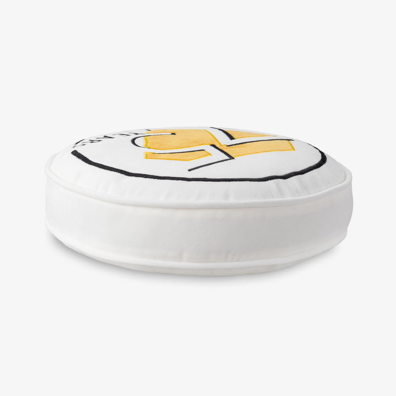 Side profile of a Peanuts 75th Anniversary Pillow on a white surface.