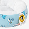 Peanuts pet bed sitting on a white surface.