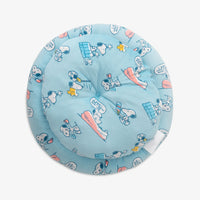 Bottom view of a blue Peanuts pet bed on a white surface.