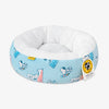 Peanuts pet bed sitting on a white surface.