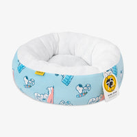 Peanuts pet bed sitting on a white surface.