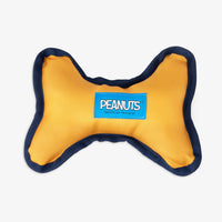 Peanuts dog toy sitting on a white surface.