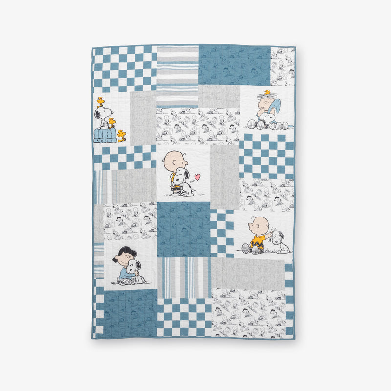 Peanuts patchwork quilt set laid flat on a white surface.