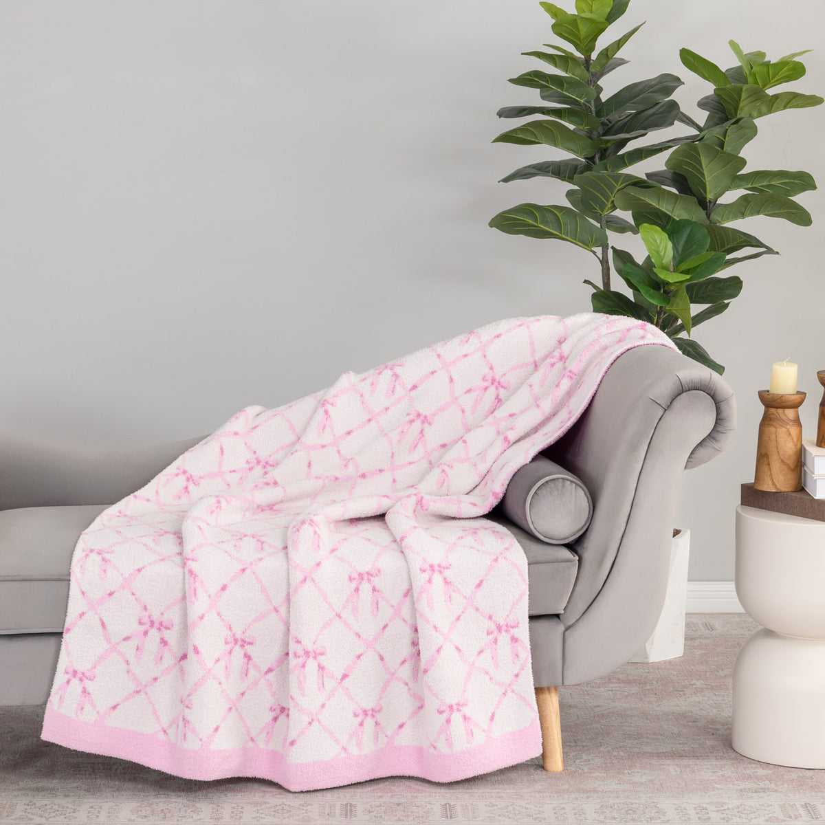 Krissy Mast Mellowsoft Bow Throw draped neatly over a grey chair.