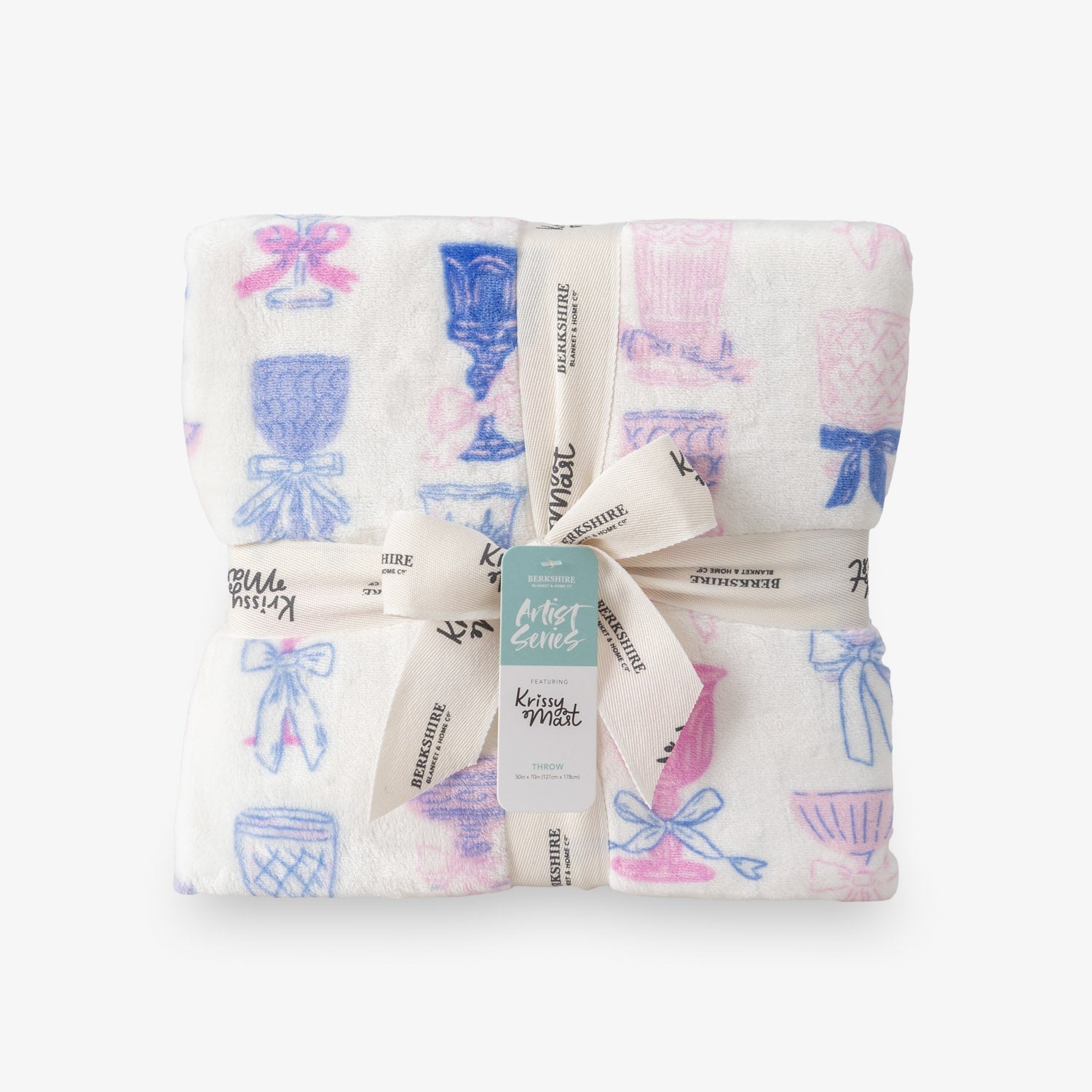 Cocktail and bows printed velvetloft throw folded neatly on a white surface.