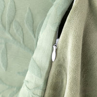 Close-up of a green textured fabric with a zipper detail