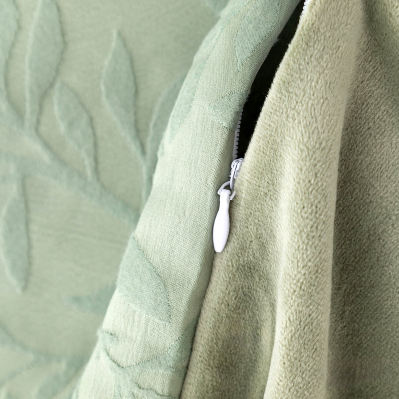 Close-up of a green textured fabric with a zipper detail