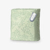 Green patterned bag with a visible brand label on a white background