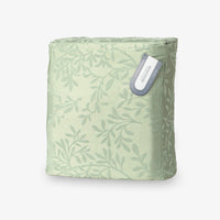 Green patterned bag with a visible brand label on a white background