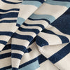Close-up of a textured fabric with blue, white, and gray pattern