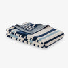 Stack of blue and white striped towels on a light gray background