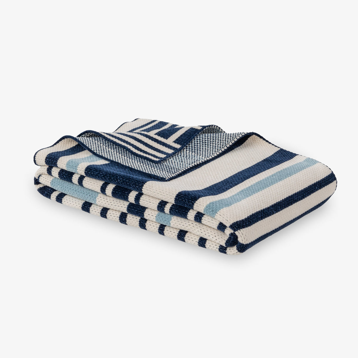 Stack of blue and white striped towels on a light gray background