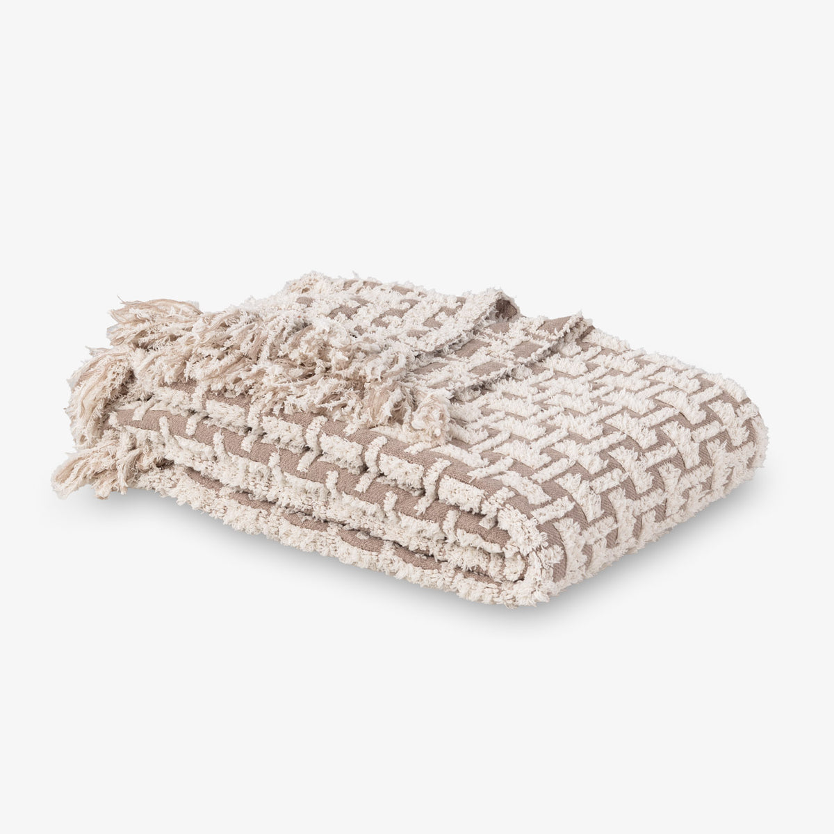 Textured blanket with tassels on a light gray background