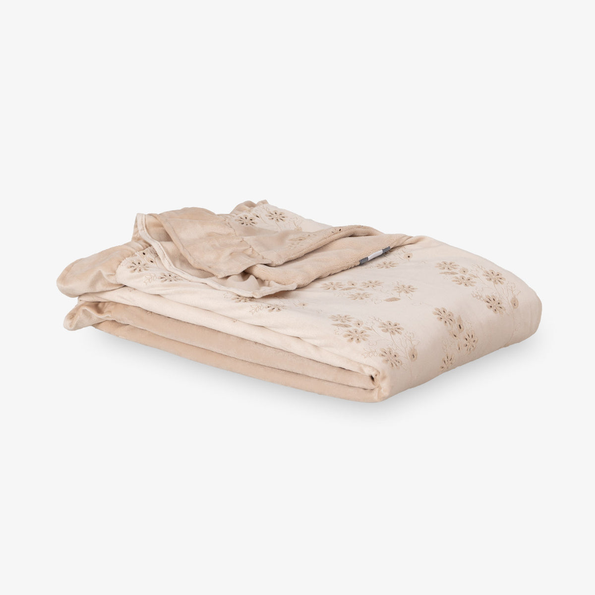 Eyelet ruffle throw folded neatly on a white surface.