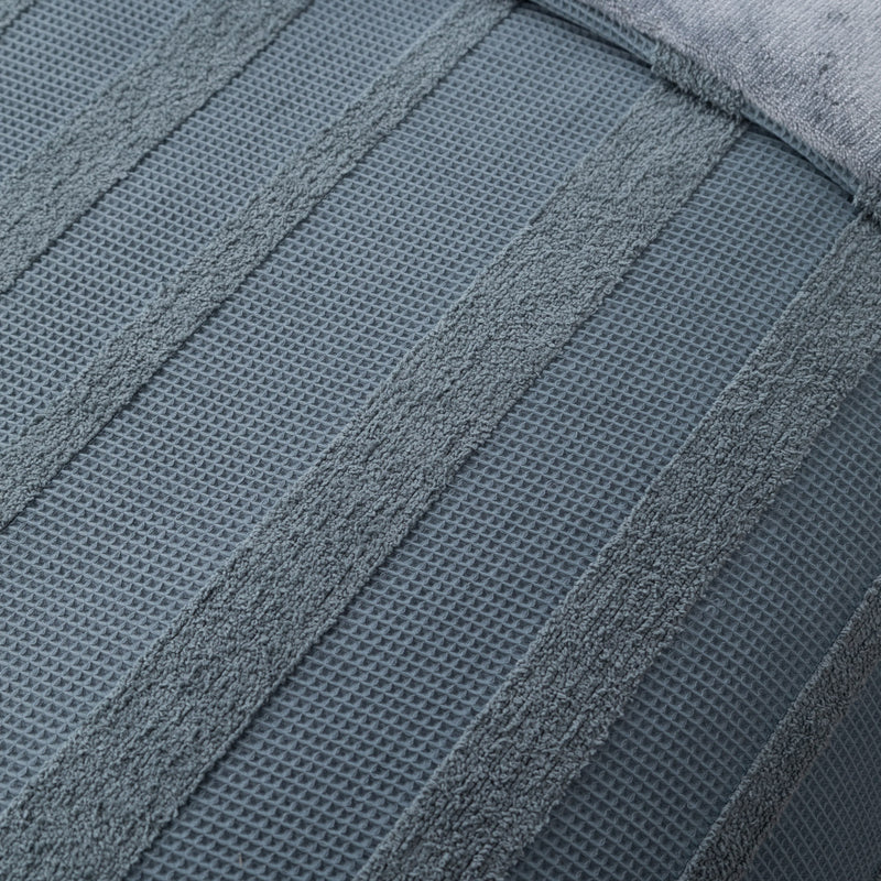 Close-up of a textured blue towel with a waffle pattern