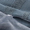 Close-up of a textured gray fabric with a zipper