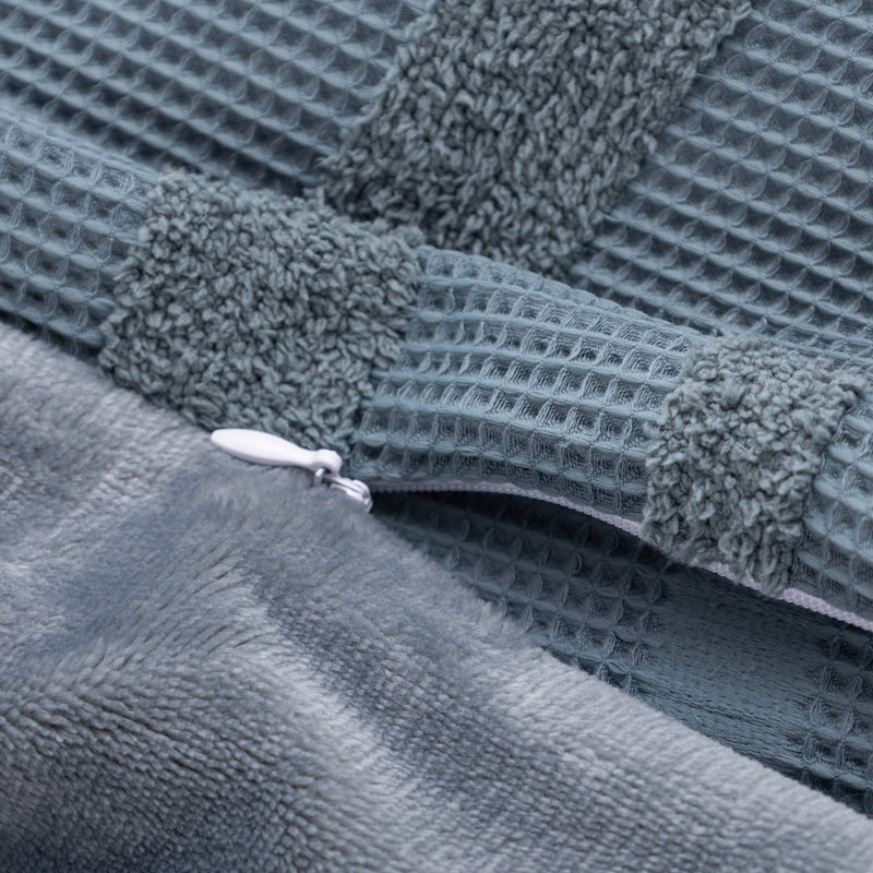 Close-up of a textured gray fabric with a zipper