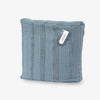 Blue textured pouch with a visible brand tag on a white background