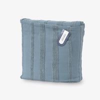 Blue textured pouch with a visible brand tag on a white background