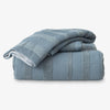Folded blue textured towels on a white background
