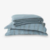 Stack of blue textured fabric on a white background