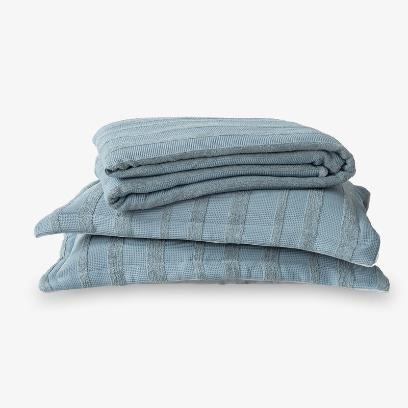 Stack of blue textured fabric on a white background