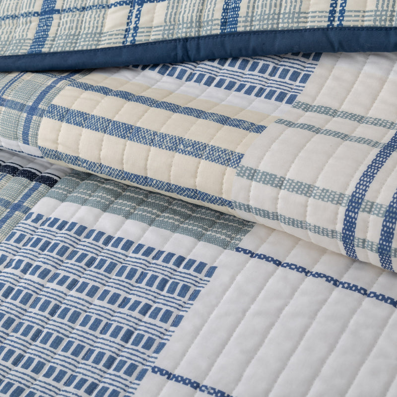 Close-up of a quilt with blue and white patterns