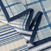 Close-up of a quilt with blue and white geometric patterns