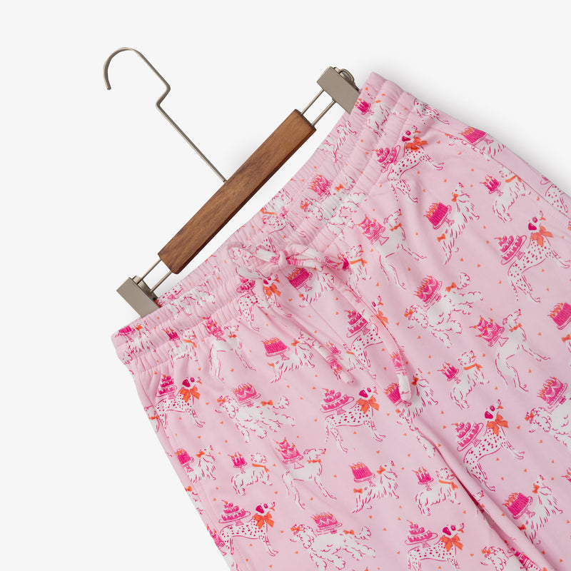 Krissy Mast printed lounge pants laid flat with a hanger on a white surface.