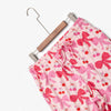 Krissy Mast printed lounge pants laid flat with a hanger on a white surface.