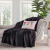 Krissy Mast dog printed pillow sitting on a black throw draped over a grey chair.