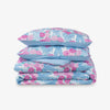 Krissy Mast floral printed comforter set folded neatly on a white surface.
