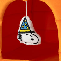 Plush toy with a wizard hat design on a red and orange background