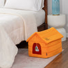 Orange pet house on a wooden floor next to a bed